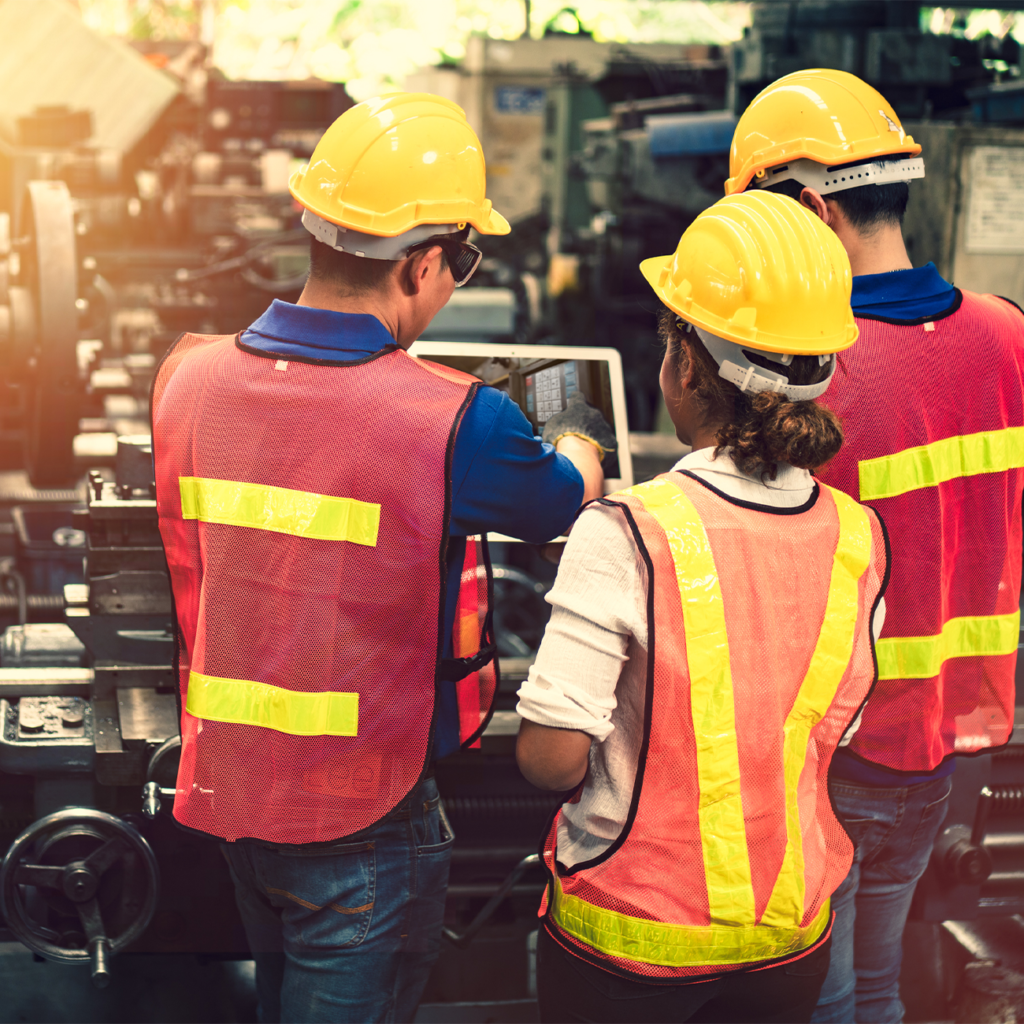 Worker in a hard hat and safety vest operating machinery