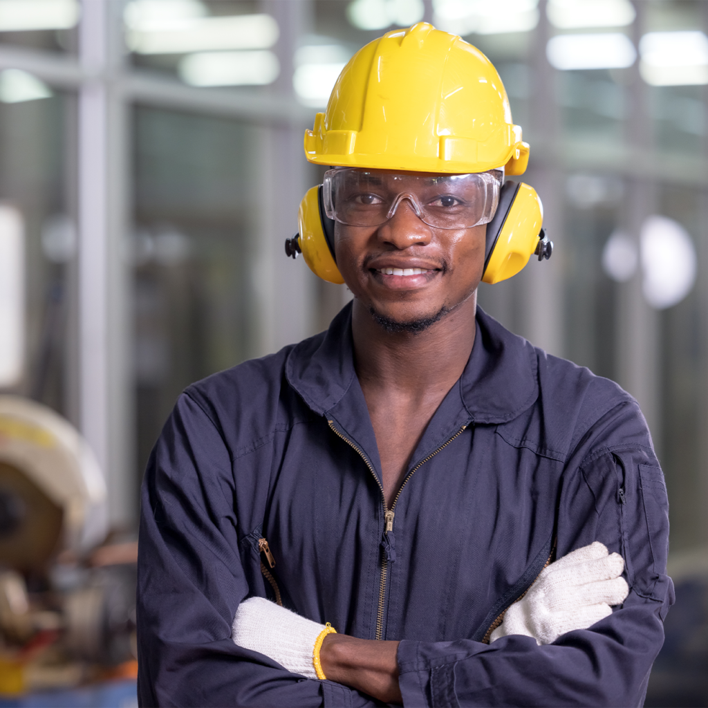 Smiling worker wearing a hard hat in a factory